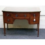 An Edwardian inlaid mahogany bow front kneehole side table, with four short and one long frieze
