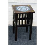 An early 20th century mahogany lamp table with inset Iznik type octagonal tiles decorated in