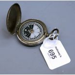 An early 20th century white metal bun cased pocket compass with push button clasp and suspension