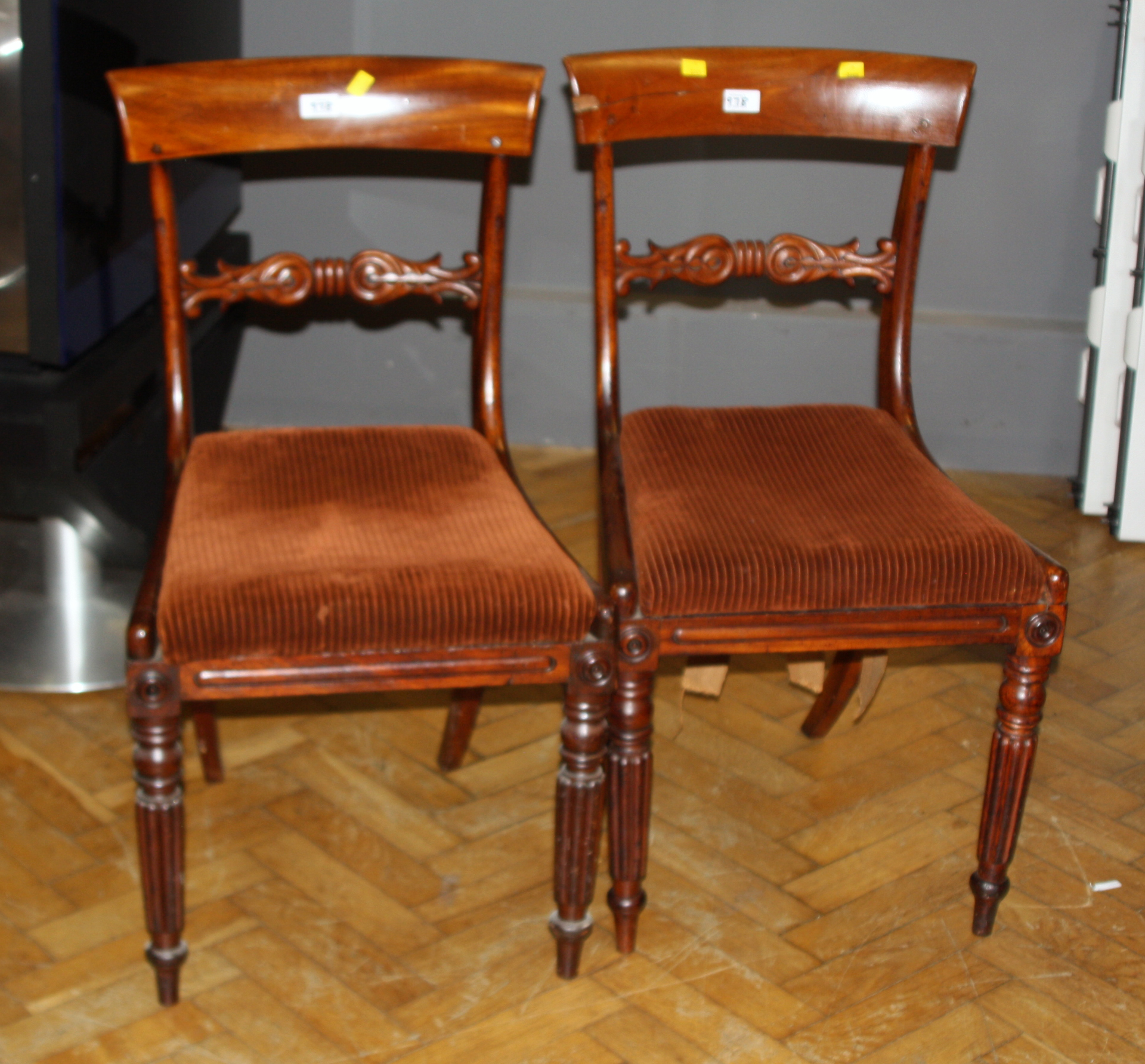 A set of seven Regency mahogany dining chairs, with broad cresting rails and drop in seats