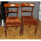 A set of seven Regency mahogany dining chairs, with broad cresting rails and drop in seats