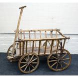 A 19th century Belgian dog cart, with gallery sides, iron bound spoked wheels and T bar handle,