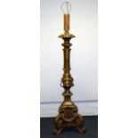 A 17th century style Venetian carved wood and gilt gesso altar candle stand (now a lamp), with