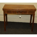 A George III mahogany fold over card table, with single frieze drawer, raised on squared supports