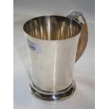 A 1920s heavy silver tankard of plain tapering form with warthog tusk handle, Birmingham 1920,