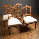 A set of four Victorian oak dining chairs, of Puginesque design, each having angular pierced