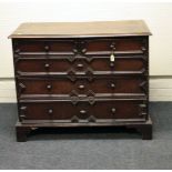 An 18th century oak chest of two over three geometrically moulded drawers with applied decoration,