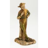 An early 20th century Royal Worcester No 2213 shot silk figure of a jester, with hand held high with