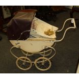 A vintage 'Swallow' pressed steel coach built pram, together with vintage hard plastic dolls,