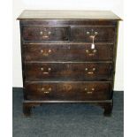 A George III oak chest, the rectangular top with moulded edge over two short and three graduated