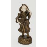Gomer, an early 20th century continental bronze and ivory figure of a lady, with a linnet cage,