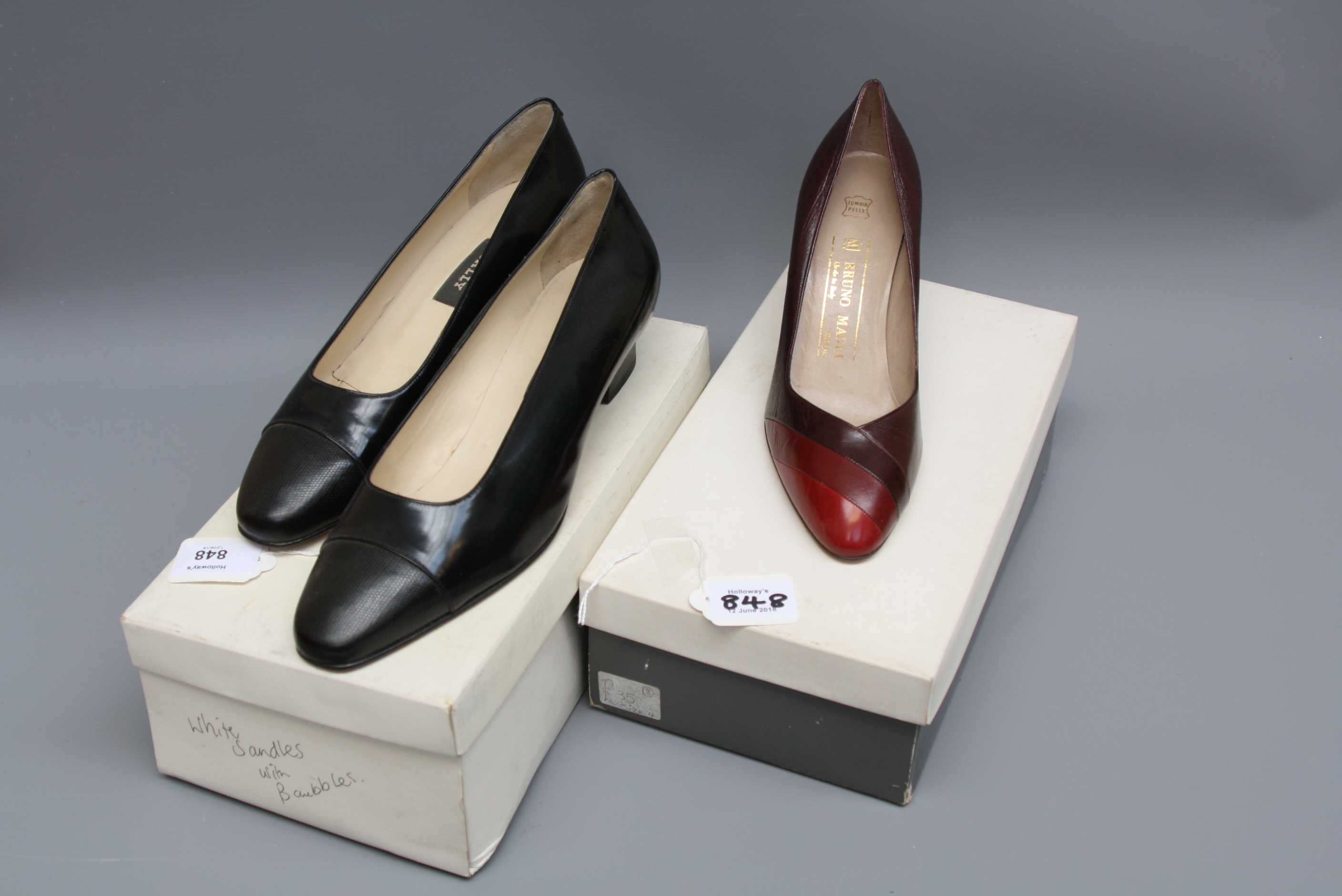A pair of burgundy Bruno Magli court shoes together with a pair of black Bally low heel shoes