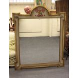 A contemporary overmantel mirror, the arched inverted breakfront frame with family crest and