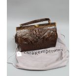 A brown crocodile handbag