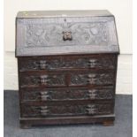 A Victorian carved oak fall front writing bureau, with lion mask detail, 91cm wide