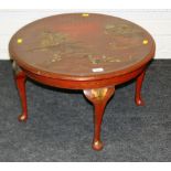 A 1920s red lacquer painted coffee table, the circular top decorated in the Chinese manner with