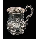 A mid Victorian christening mug, baluster form the lobed body chased and engraved with flowers and