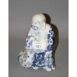 A 20th century Chinese blue and white porcelain figure of Hotei, with flowing robe decorated in