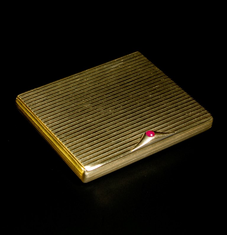 A 9ct gold compact, rounded rectangular with reeded bands to cover, sides and base, circular