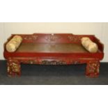 A 19th century Chinese red lacquered opium bed, with carved and pierced detail, 200cm long