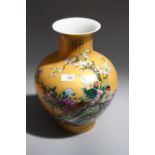 A 20th century Chinese gold ground baluster vase painted with quails in landscapes, bearing poetic