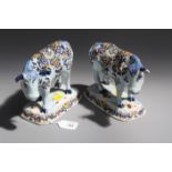 A pair of Paris France figures of cows, decorated with flowers on rectangular bases, bearing APK