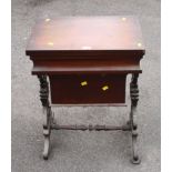 A Victorian mahogany foldover work table with bag beneath, raised on lyre supports and scroll