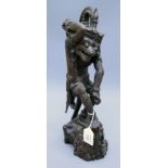 A well carved Balinese figure of a demon on a naturalistic base, 40cm high