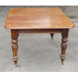 An early Victorian figured mahogany pull-out rectangular dining table, with segmented melon legs and