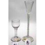 An 18th century tulip bowled dwarf ale glass, with plain stem over a spreading foot, 12.5cm high,