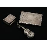 A silver card case, shaped rectangular, profusely engraved with scrolling foliage around a central