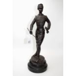 A French 19th century bronze figure of a Franco Prussian officer, with gloves and swagger stick,