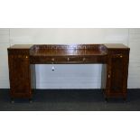 An early 19th century mahogany, brass inlaid twin pedestal sideboard, the D shape top with low