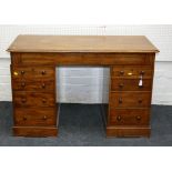 A Victorian mahogany kneehole pedestal desk, with a long frieze drawer above two pedestals each of