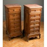 A pair of 19th century French walnut bedside chests, each having rouge marble inset square top