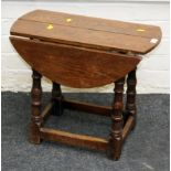 A late 17th century style oak two flap occasional table with turned supports, 61cm wide