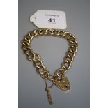 A 9ct gold engraved curb pattern bracelet, with padlock clasp