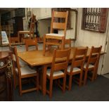 A contemporary golden oak dining table, the rectangular planked top with cleated ends, on