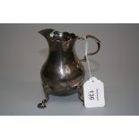 A George III cream jug, inverted pear shape with leaf capped double scroll handle and three fluted