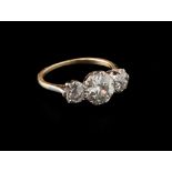 A three stone half hoop diamond ring, the principle old brilliant cut diamond in claw mount, with