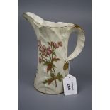 A Royal Worcester leaf moulded jug, florally decorated on an ivory and gilt ground, green printed