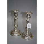 A pair of Victorian silver plated table candlesticks, each with florally cast detachable sconce,