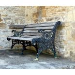 An early 20th century heavy cast iron three seat garden bench, with pierced and scroll ends and