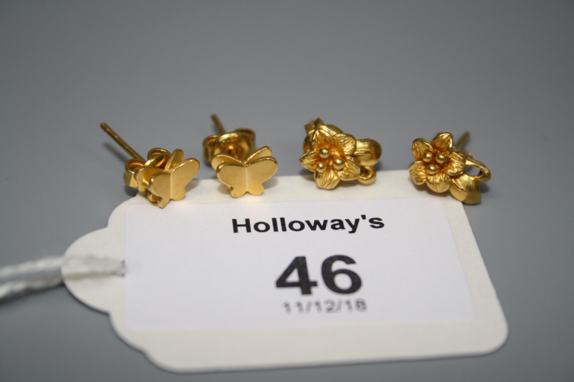 A pair of flower head earrings, together with a pair of butterfly earrings marked '999'