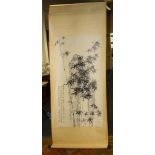 A Chinese calligraphic scroll on silk background printed with rock gardens and stands of bamboo,