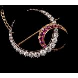 A late Victorian ruby and diamond double crescent brooch, the principle crescent of graduated old