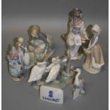 A small collection of Lladro, including a seated Geisha with fan, kneeling girl feeding ducks, group