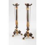 A pair of 19th century Louis Phillipe patinated and gilt single sconce candlesticks with winged