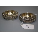 Craddock and Reid, a pair of circular silver salts with reeded, fluted edge and gilt interior,