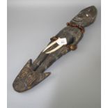 A probably Papua New Guinea carved wood and polychromic painted food hook of figural form with